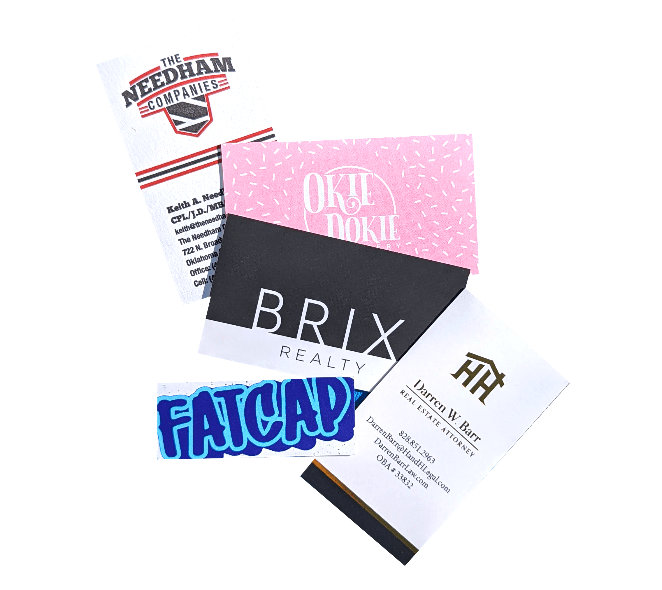 Various business cards scattered. Pictured is the Needham Companies, Okie Dokie Bakery, Brix Realty, Fatcap, and HandHeim Legal